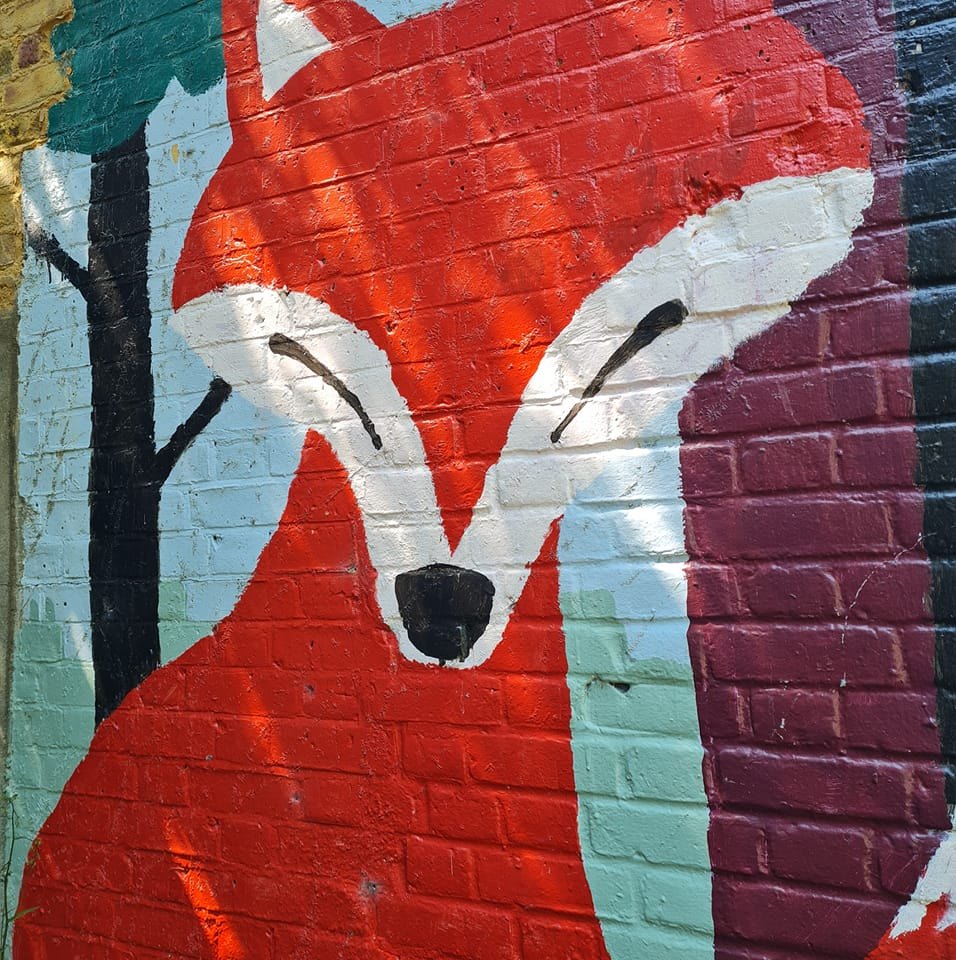 orange fox painted on a wall
